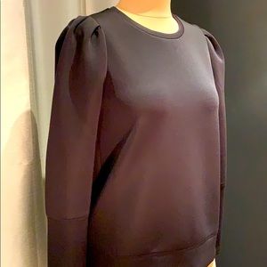Puff shoulder sleek sweatshirt style top.